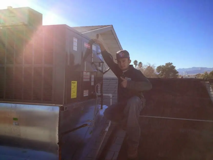 HVAC technician performing HVAC Inspection on a rooftop unit in Schertz